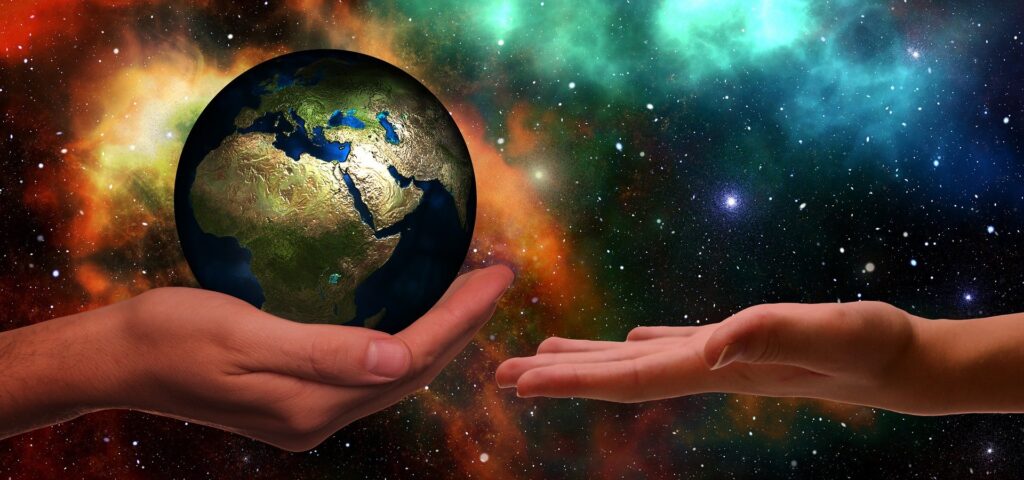 person holding world globe in hand
