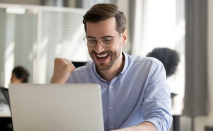 excited man sitting at computer found bestselling product