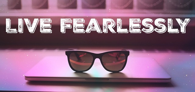 sunglasses on top of a computer with live fearlessly written above