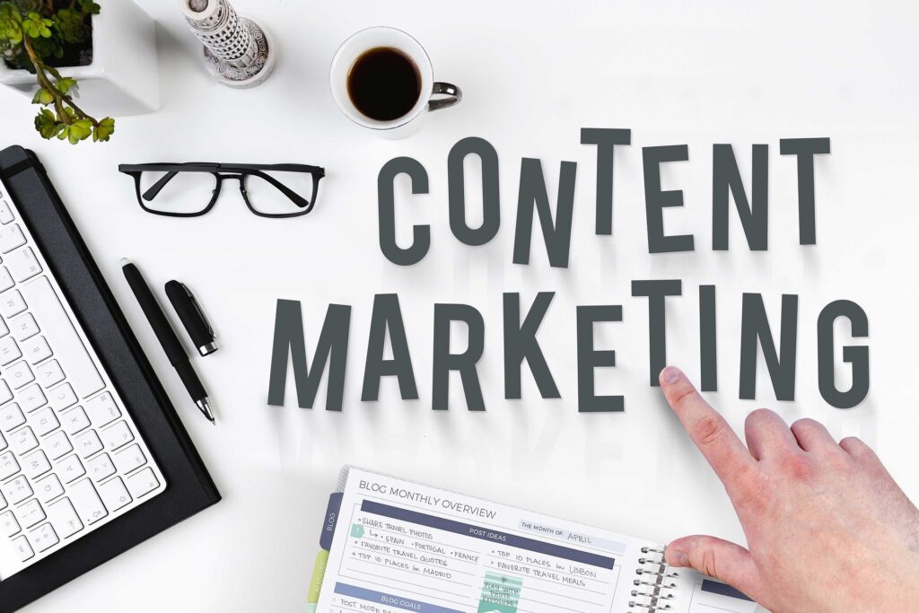 hand pointing to content marketing letters on a work desk