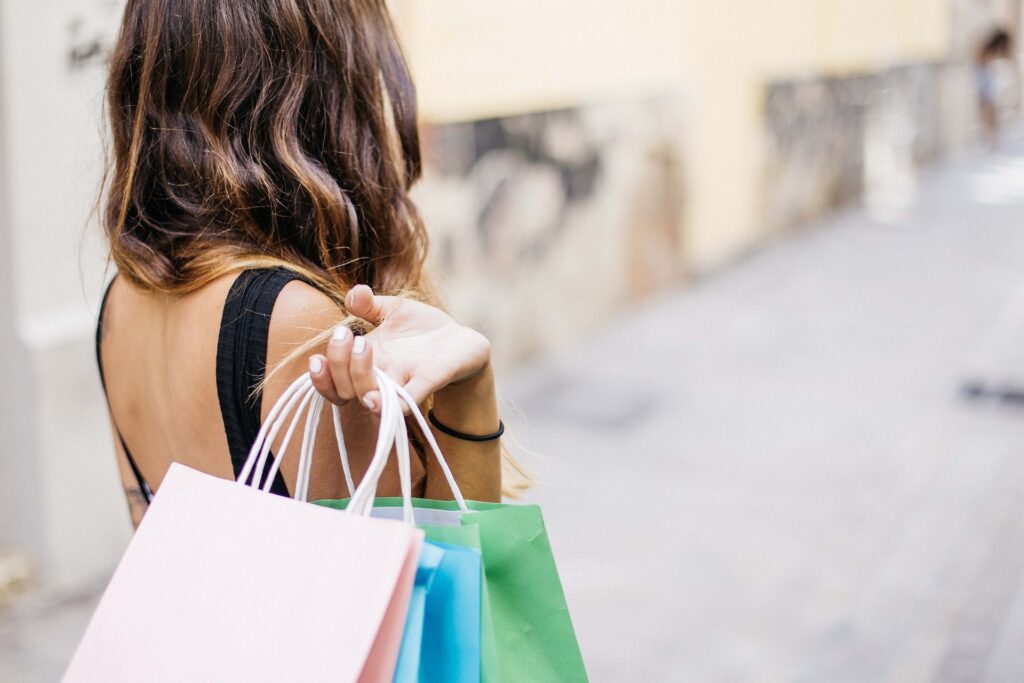 customer holding multiple shopping bags