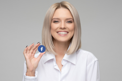 smiling woman holding a facebook counter