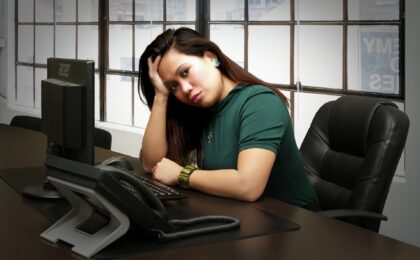 woman with head in hand sitting at a desk featured image for 5 common mistakes to avoid when using plr blog post