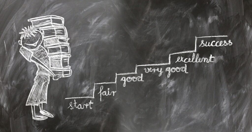 chalk drawing of person carrying 5 business success tips you need to know books up a set of stairs