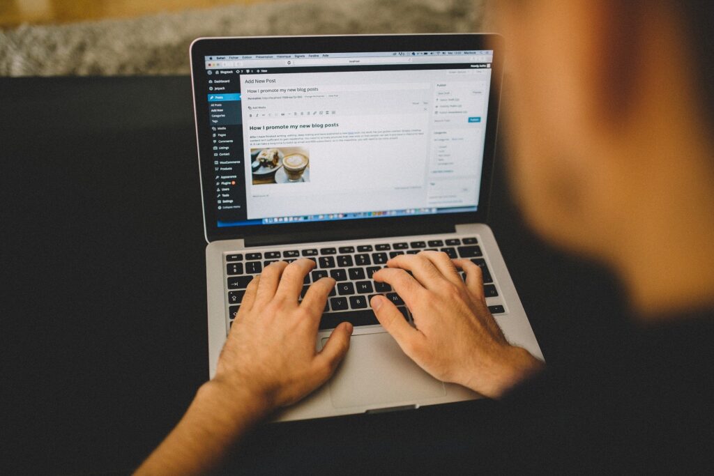 man sitting at laptop creating a blog to make his business more personal and interesting