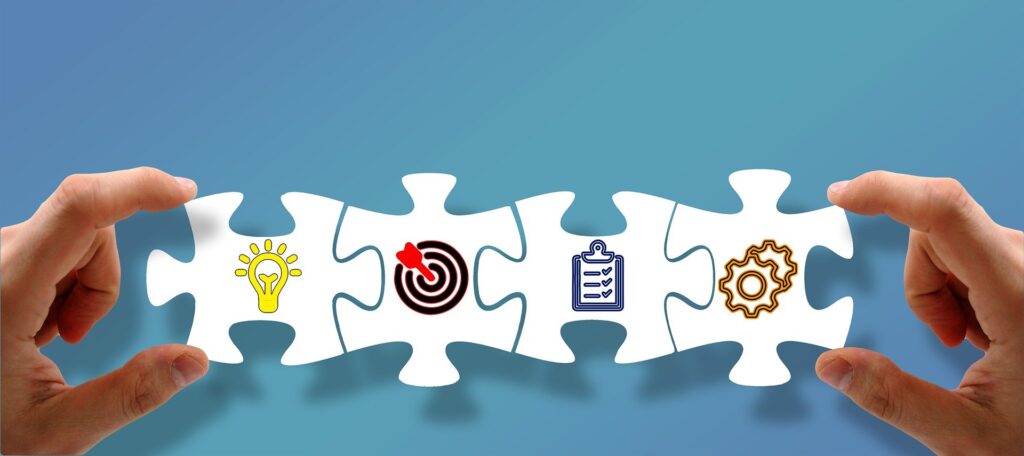 hands holding line of puzzle pieces joined together depicting steps to market your business effectively ideas