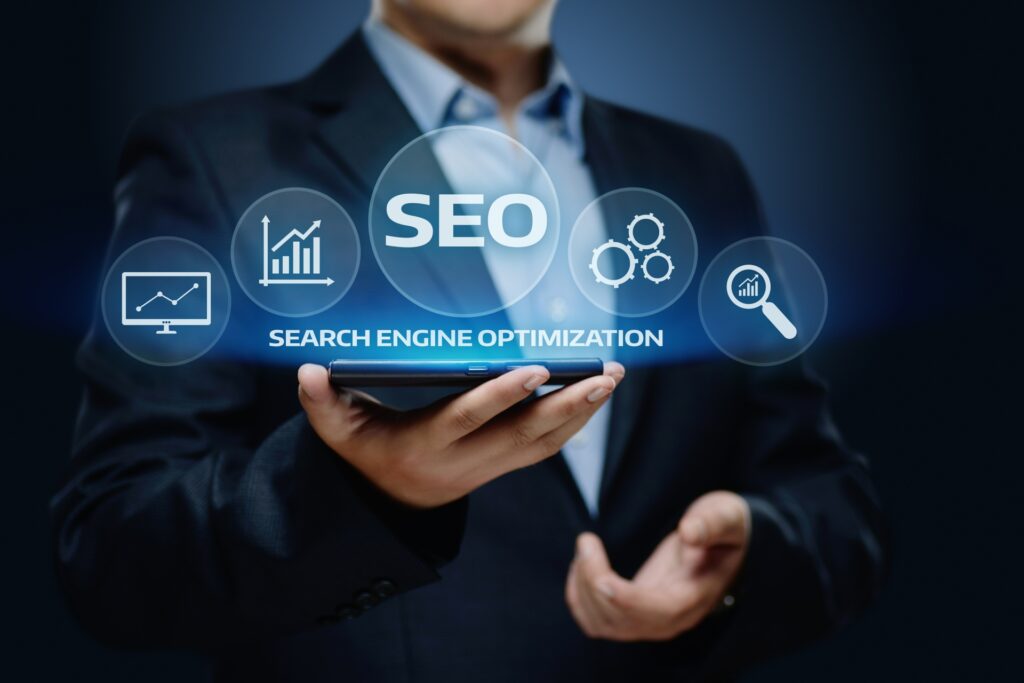 man in suit holding a device that's illuminated with the words search engine optimisation